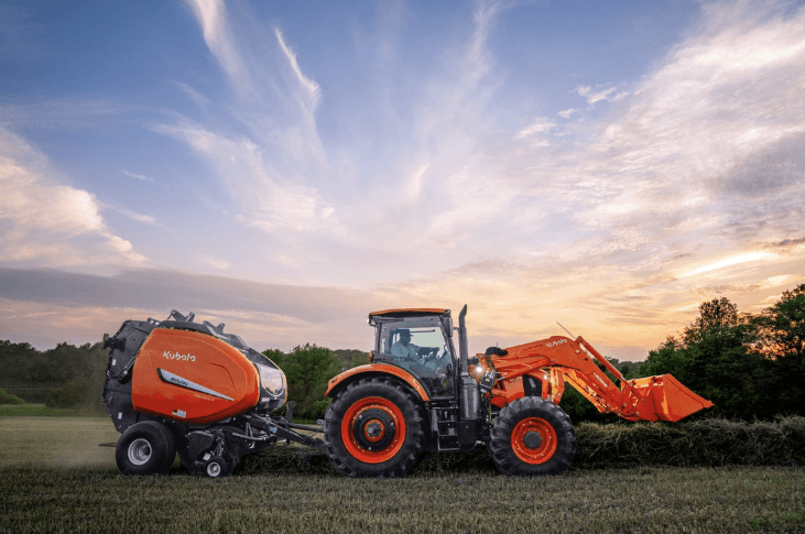 An agricultural tractor with a baler attachment on the rear